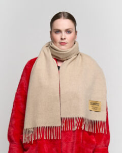 A folded plaid cashmere scarf in a high-quality gift box.